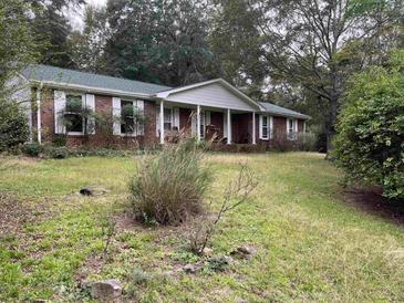 Brick ranch house with covered porch at 5297 Rock Springs Rd, Lithonia, GA 30038