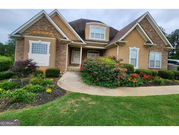 Two-story house with stone accents and landscaped yard at 1995 Evergreen Se Dr, Conyers, GA 30013