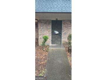 Brick building with a metal security door and a small ramp for accessibility at 91 Peyton Sw Pl, Atlanta, GA 30311
