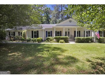 Charming brick ranch home with a spacious front yard and mature trees at 4505 Cochran Mill Rd, Fairburn, GA 30213