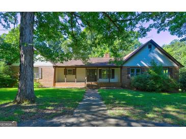 Ranch house with brick and siding exterior, nestled on a spacious lot at 3655 Highway 81 W, Hampton, GA 30228