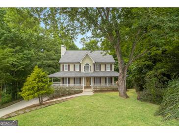 Two-story home with a front porch and landscaped yard at 267 Wellington Walk, Douglasville, GA 30134