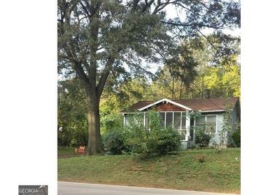 Small house with screened porch and large tree at 3224 N Decatur Rd, Scottdale, GA 30079