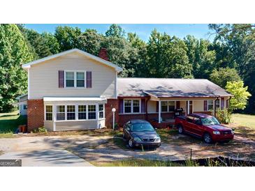 Ranch style home with a large yard and trees at 5110 Macland Rd, Powder Springs, GA 30127