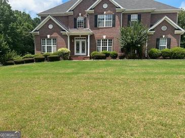 Brick house with a large front yard at 1221 Rhodes Sw Walk, Conyers, GA 30094