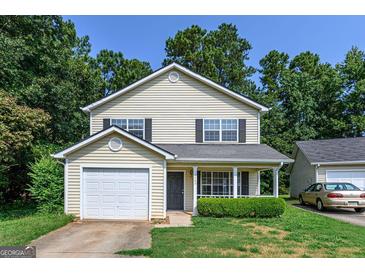 Two story house with a yard and attached garage at 3482 Sweetgum Ln, Decatur, GA 30032