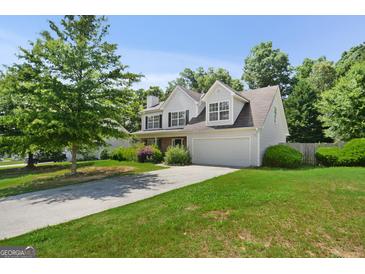 Two-story home with a two car garage and well manicured lawn at 3463 Madison Farm Way, Snellville, GA 30039