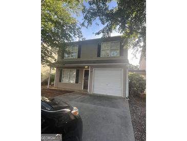 Two story house with attached garage and landscaping at 449 Kara Ln, Mcdonough, GA 30253