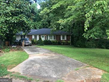 Brick ranch house with a large front yard and driveway at 2093 Wildrose Dr, Decatur, GA 30032