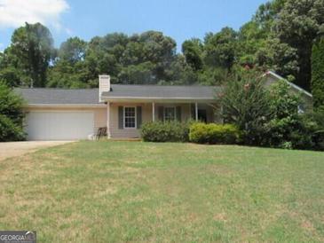 Charming ranch home with attached garage and spacious yard at 235 Lazy Hollow Ln, Covington, GA 30016