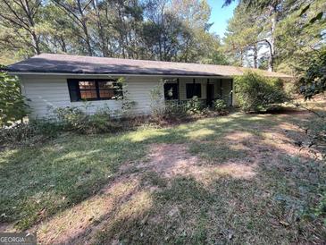 Ranch-style home with a large yard and mature trees at 1569 King Mill Rd, Mcdonough, GA 30252