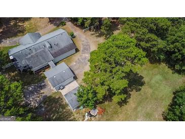 Aerial view of house, detached garage, and expansive green space at 1072 Harbins Rd, Dacula, GA 30019