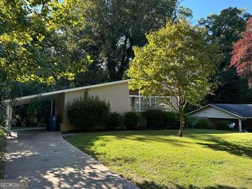 Charming ranch home with a well-maintained lawn and driveway at 2213 Westover Dr, East Point, GA 30344
