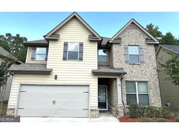 Two-story house with a large garage and brick facade at 700 Emporia Loop, Mcdonough, GA 30253