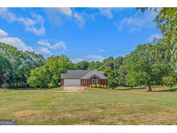 Brick ranch house with attached garage and large yard at 825 S Bethany Rd, Locust Grove, GA 30248