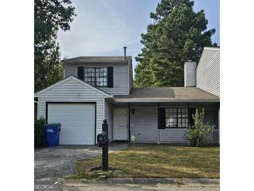 House exterior, featuring a garage and front yard at 602 Pine Tree Trl, College Park, GA 30349