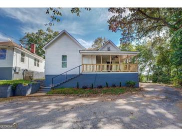 Charming house with a porch, new paint, and landscaping at 2 Poplar St, Porterdale, GA 30070
