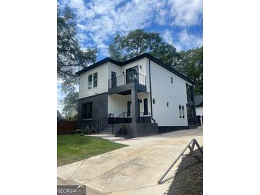 Modern two-story home with gray brick and white siding at 3419 Hamilton Ave, Hapeville, GA 30354