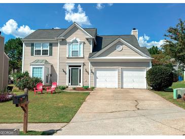 Two-story house with a double garage and landscaping at 2206 Sugar Maple Nw Ct, Acworth, GA 30101