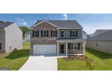 Two story home with brick and siding accents. Features a two car garage at 532 Whitman Lane # 9, Stockbridge, GA 30281