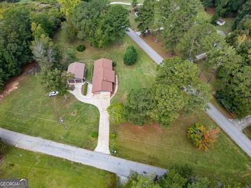 Aerial view of house, detached garage, and large yard at 5225 Bailey Sw Rd, Conyers, GA 30094