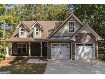 Two-story house with a brick facade and a two-car garage at 5447 Centry Dr, Villa Rica, GA 30180