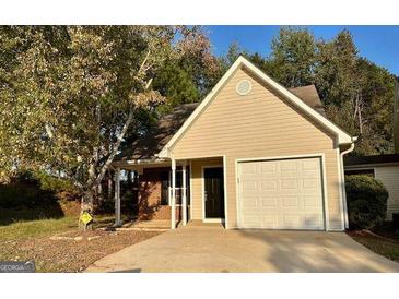 Tan-colored house with a one-car garage at 516 Jaclyn Cir, Mcdonough, GA 30253