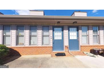 Brick building with two blue doors and a spacious patio at 4173 Stillwater Dr, Duluth, GA 30096