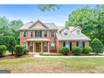 Two-story brick home with landscaping at 920 Eskew Rd, Mcdonough, GA 30252