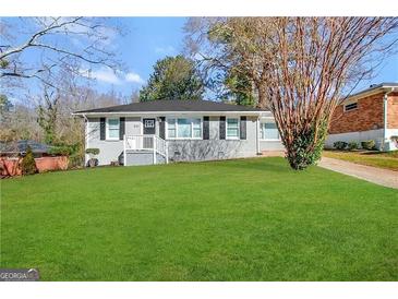 Charming ranch home with gray exterior, updated windows, and a manicured lawn at 2164 Rockhaven Cir, Decatur, GA 30032