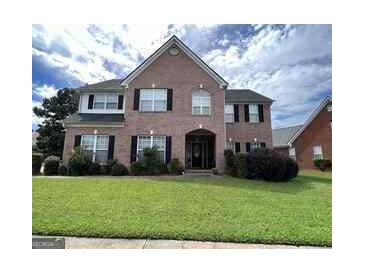 Two story brick home with a manicured lawn at 1402 Aramore Se Dr, Conyers, GA 30013