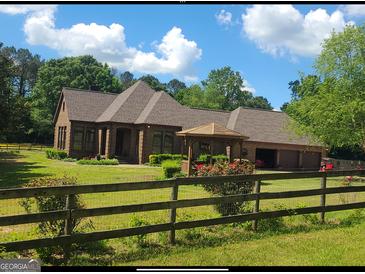Brick house with attached garage and gazebo at 7866 Hwy 54, Sharpsburg, GA 30277
