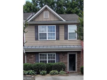 Two-story townhome with stone accents and landscaping at 2628 Haligan Pointe, Riverdale, GA 30296