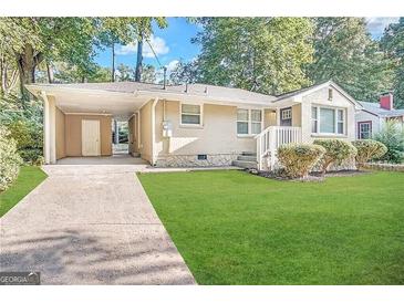 Charming ranch home with carport and manicured lawn at 3564 Glenwood Rd, Decatur, GA 30032