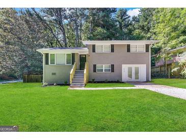 Newly renovated ranch home with gray exterior and attached garage at 4310 Bakers Ferry Sw Rd, Atlanta, GA 30331