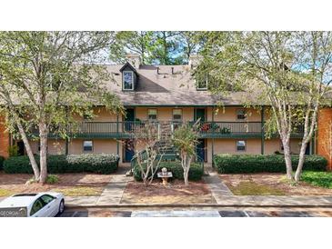 Two-story building exterior with multiple units, landscaping, and fountain at 312 Brittany Ct, Duluth, GA 30096