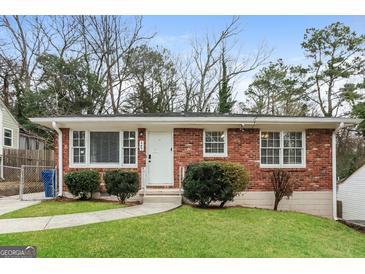 Brick ranch house with landscaped lawn and walkway at 1262 Lorenzo Sw Dr, Atlanta, GA 30310