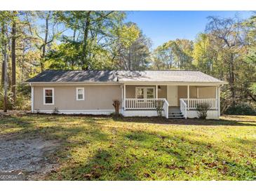 Quaint single-story home with front porch and lush lawn at 465 Haynie Rd, Moreland, GA 30259