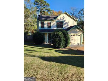 Two-story house with a well-maintained lawn and attached garage at 6722 Bent Creek Dr, Rex, GA 30273
