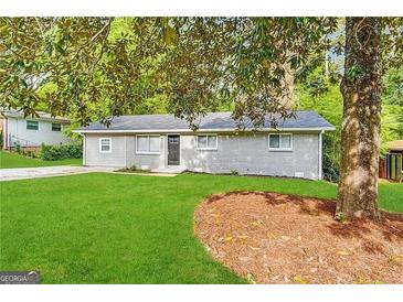 Charming ranch home with gray siding and green lawn at 1919 Glenmar Dr, Decatur, GA 30032