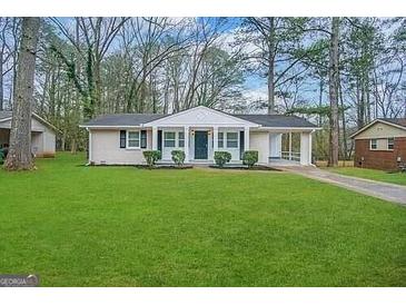Ranch style home with a spacious lawn and covered porch at 4433 Mercer Rd, Decatur, GA 30035
