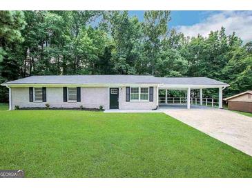 Newly renovated ranch home with carport and spacious lawn at 2997 Tara Woods Dr, Douglasville, GA 30135