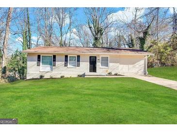 Brick ranch home with a well-maintained lawn and driveway at 2190 Westover Dr, East Point, GA 30344