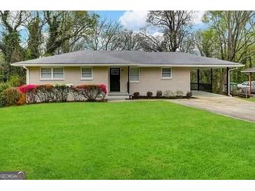 Ranch style home with carport and well-maintained lawn at 2138 Springdale Rd, Atlanta, GA 30315