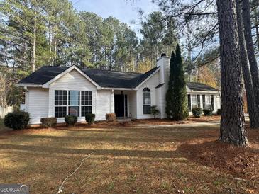 Charming single-story home with a landscaped front yard and trees at 116 Winthrop Dr, Sharpsburg, GA 30277