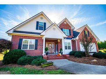 Brick two-story house with a welcoming front porch and landscaping at 1285 E Hwy 5, Carrollton, GA 30116