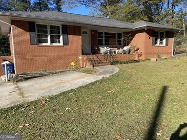 Brick ranch house with a large yard and driveway at 8965 Campbellton St, Douglasville, GA 30134
