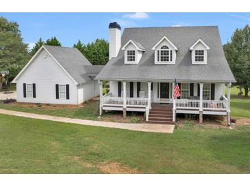 Two story house with wrap around porch and detached garage at 2110 Mcgarity Rd, Mcdonough, GA 30252