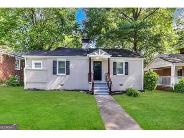 Charming ranch home with freshly painted exterior and manicured lawn at 1327 Sharon Nw St, Atlanta, GA 30314
