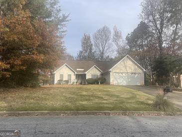 Ranch style home with mature trees and landscaping at 3418 Poplar Ridge Dr, Rex, GA 30273